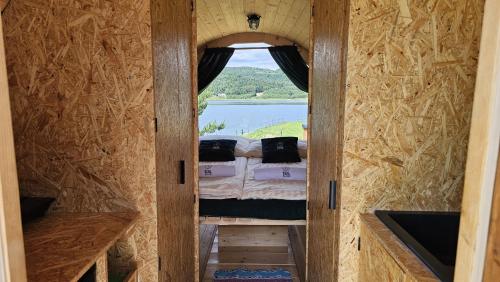 a room with a bed inside of a tiny house at Czill Beczki in Mucharz