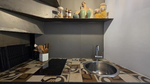 a bathroom with a sink on a tiled floor at La Caverna - Bari Vecchia, Fronte Mare in Bari