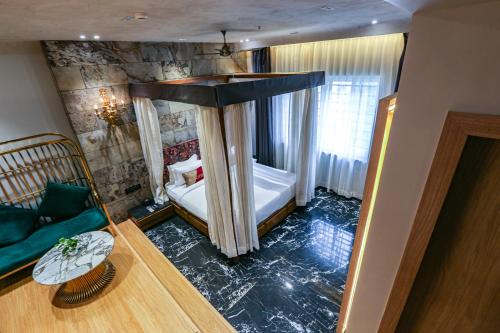 a bedroom with a canopy bed in a room at Aceotel Select Aria, Bhopal -A Luxury Boutique Hotel in Bhopal