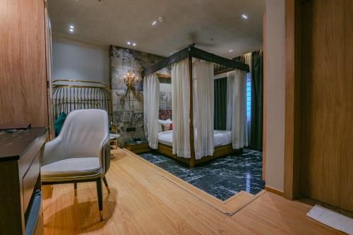 a room with a bedroom with a bed and a mirror at Aceotel Select Aria, Bhopal -A Luxury Boutique Hotel in Bhopal
