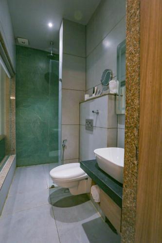 a bathroom with a toilet and a sink and a shower at Aceotel Select Aria, Bhopal -A Luxury Boutique Hotel in Bhopal