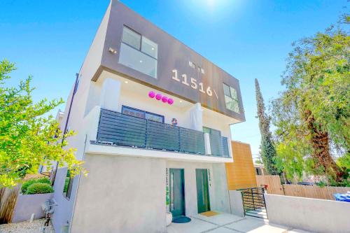 a large white building with a sign on it at H- Fab Family 5BD 4,5BA NoHo Escape Near Universal with Games, Deck, Parking in North Hollywood