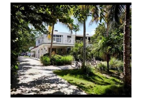 a house with palm trees in front of a driveway at Casa Morada in Islamorada