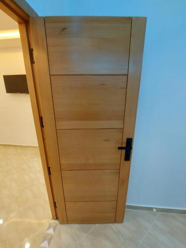 a wooden door in the middle of a room at Arizona Hotel in Martil