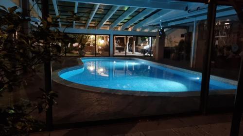 a swimming pool in a building at night at Castelnuovo Workx in Castelnuovo