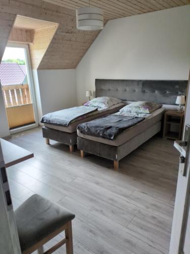 a bedroom with two beds and a window at Pokoje Gościnne u Oli in Wisełka