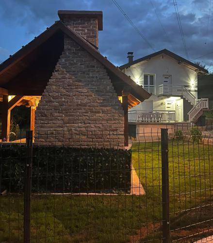 a brick house with a fence in front of a house at White house Sarajevo in Sarajevo