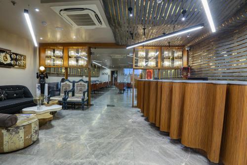 a bar in a salon with a couch and chairs at Aceotel Select Aria, Bhopal -A Luxury Boutique Hotel in Bhopal