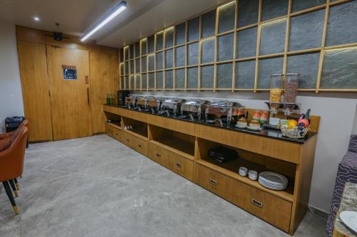 a room with wooden cabinets and shelves with food at Aceotel Select Aria, Bhopal -A Luxury Boutique Hotel in Bhopal