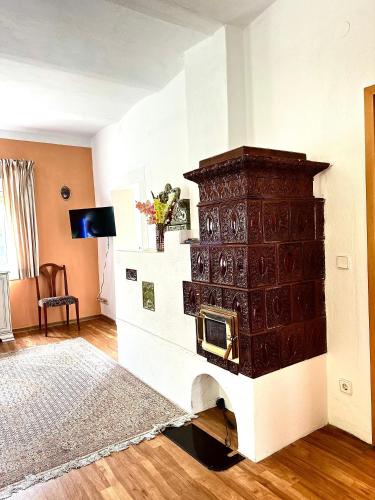 a living room with a large fireplace in the wall at Ferienwohnung Gänseblümchen in Feistritz an der Gail