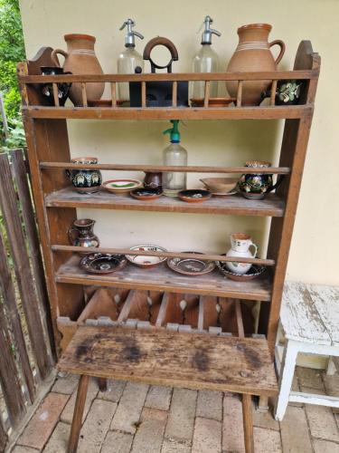 a shelf filled with pots and pans at Enikő Vendégház in Vajdácska