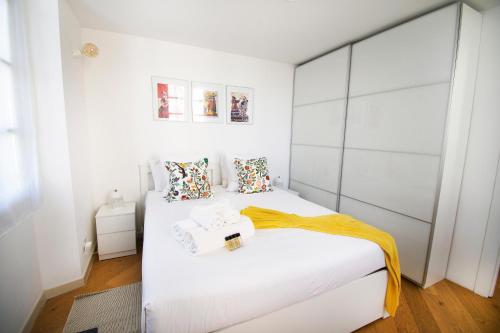 a bedroom with two beds with white walls at Princes Victoria Standing Presta in Cannes