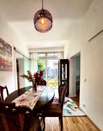 a dining room with a table and chairs and a chandelier at Ferienwohnung Gänseblümchen in Feistritz an der Gail