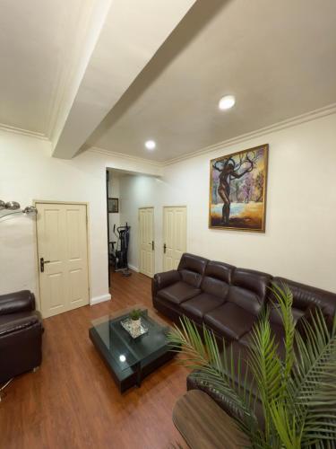 a living room with a couch and a table at Lauras cozy 2 bedroom apartment in Lagos
