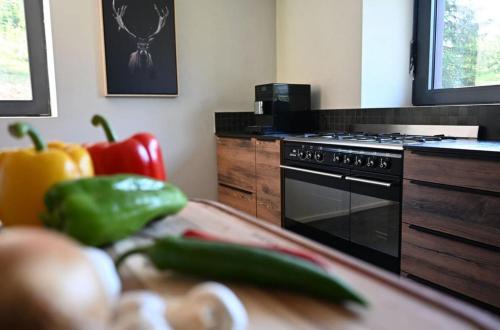 a kitchen with a counter with vegetables on a table at La loge de la Dolarde in Prémanon