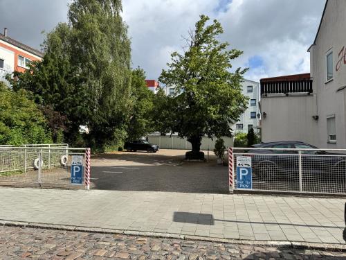 a parking lot with a gate with parking signs on it at Hotel Runge 24 7 Check In & Free Parking in Kiel