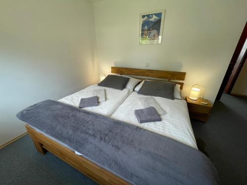 a bedroom with a large bed with two pillows on it at Apartmány nad Šlikovkou in Jáchymov