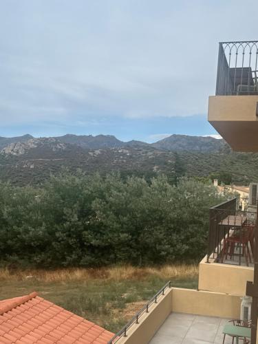 a view of the mountains from the balcony of a house at Résidence Apa Nera in Calenzana