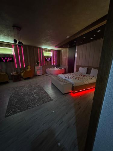 a room with two beds on the floor with red lights at Hotel Iliria in Orllan