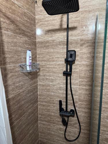 a shower with a shower head in a bathroom at Hotel Iliria in Orllan