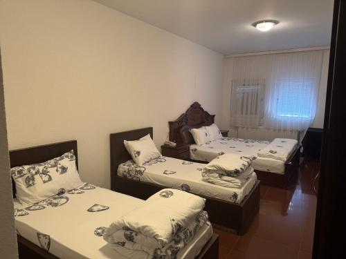 a group of three beds in a room at Hotel Iliria in Orllan