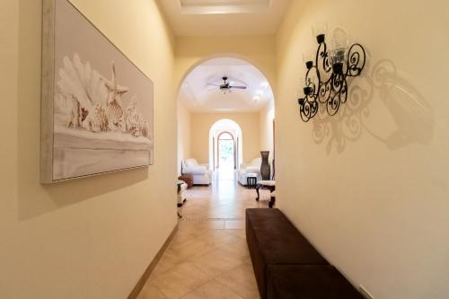 a hallway of a home with a chandelier at Palmarenas Pacific Retreat in El Chirú
