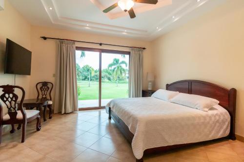 a bedroom with a bed and a sliding glass door at Palmarenas Pacific Retreat in El Chirú
