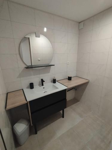 a bathroom with a sink and a mirror and a toilet at Maison au calme L'échappée Tarnaise in Cunac