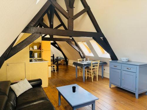 a living room with a couch and a table at Meublé au coeur de la cité Vauban in Gravelines