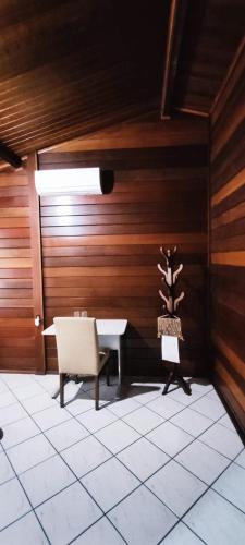 a dining room with a table and a chair at Pousada Família Capetti in Bauru