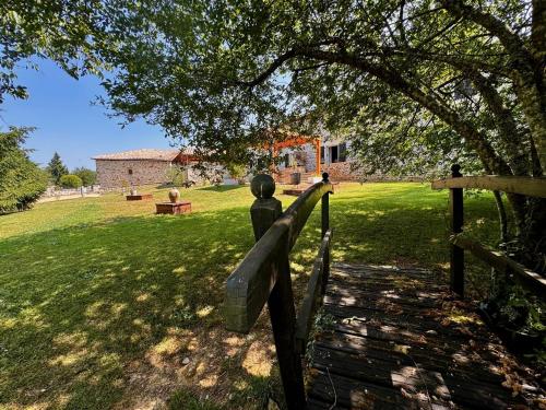 a statue of a person standing on a fence in a field at Domaine de Brise Bois - Chambres & Gîtes in Rouzède