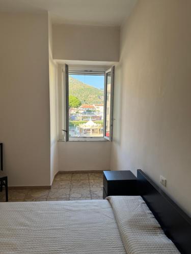 a bedroom with a bed and a large window at La Bella Vista 9 - Fondi in Fondi