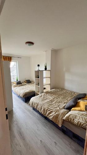 two beds are in a room with at Jako doma in Ivaň