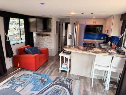 a kitchen and a living room with a red couch at b3 Couples Therapy Yacht in La Crosse