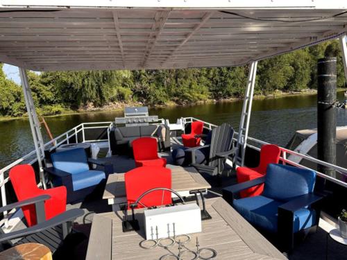 a boat with chairs and tables on a river at b3 Couples Therapy Yacht in La Crosse