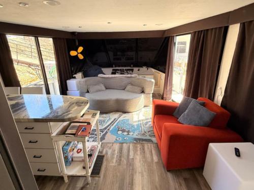 a living room with a red chair and a couch at b3 Couples Therapy Yacht in La Crosse