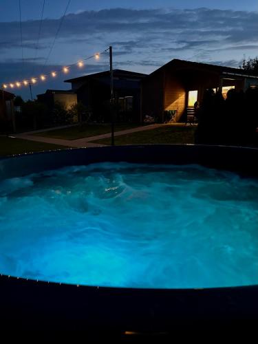a large pool of blue water in front of a house at Silva in Rewal