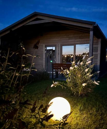 a light in the grass in front of a house at Silva in Rewal