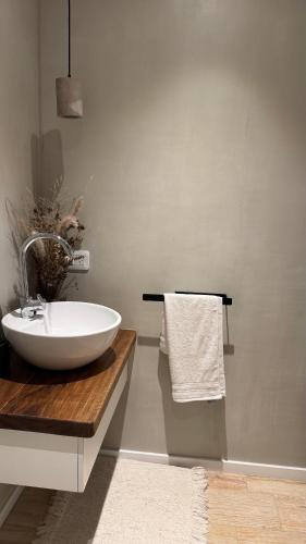 a bathroom with a white sink and a towel at Departamento en Rojas in Rojas