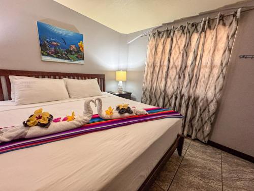 a bedroom with a bed with stuffed animals on it at Caribbean Shores Belize in Hopkins