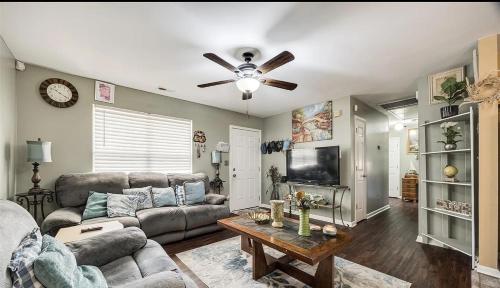 a living room with a couch and a ceiling fan at Cozy hill in Rock Hill