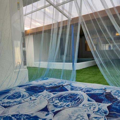 a blue and white bed in a tent at Casa Rural Mayne in Villafranca de los Caballeros