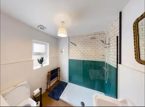 a bathroom with a tub and a sink and a shower at 4 Bedroom Belfast Townhouse in Belfast
