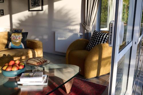 a living room with two chairs and a glass table at Greenvale Bed and Breakfast in Oban