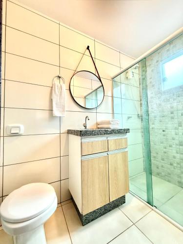 a bathroom with a toilet and a shower at MORADA GARAPEIRA in Guarda do Embaú