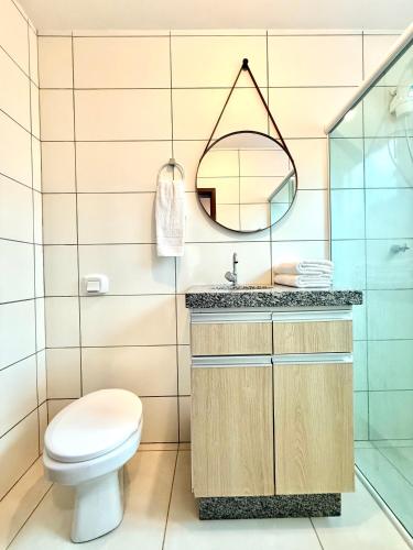 a bathroom with a toilet and a sink at MORADA GARAPEIRA in Guarda do Embaú