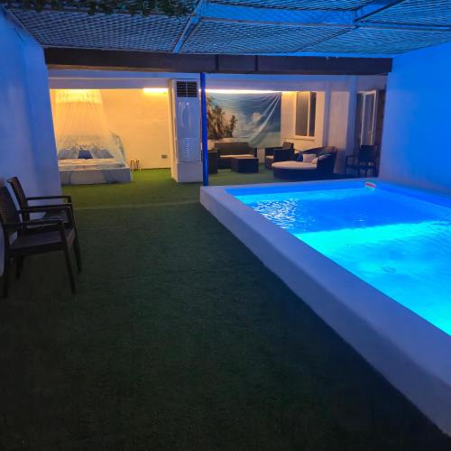 a large swimming pool lit up at night at Casa Rural Mayne in Villafranca de los Caballeros