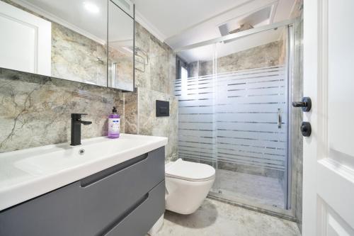 un bagno con lavandino, WC e doccia di Villa TURK a Fethiye