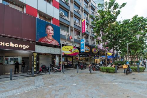 a street in a city with many shops at Hotel Grand Orchard in Gua Sai
