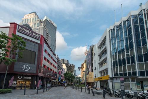 a street in a city with buildings and motorcycles at Hotel Grand Orchard in Gua Sai